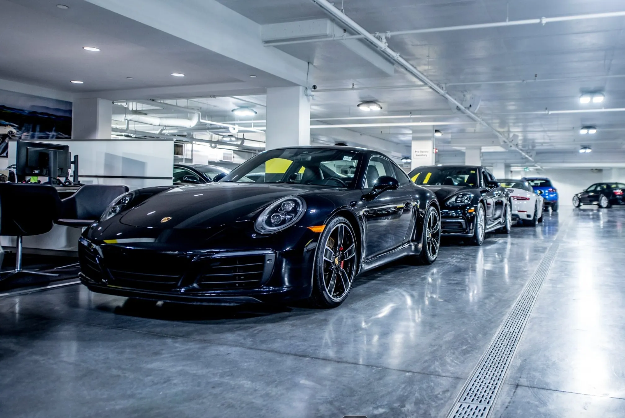 A spotless luxury car dealership showroom floor